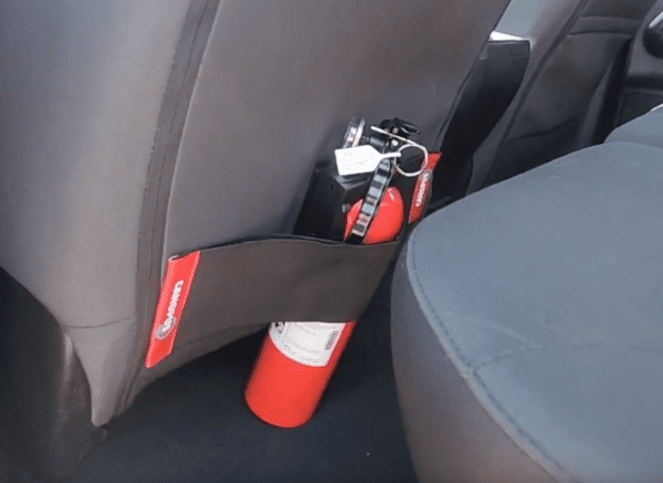 fire extinguisher mounted behind the driver's seat