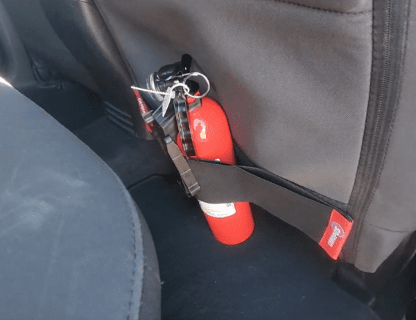 fire extinguisher mounted behind the passenger seat