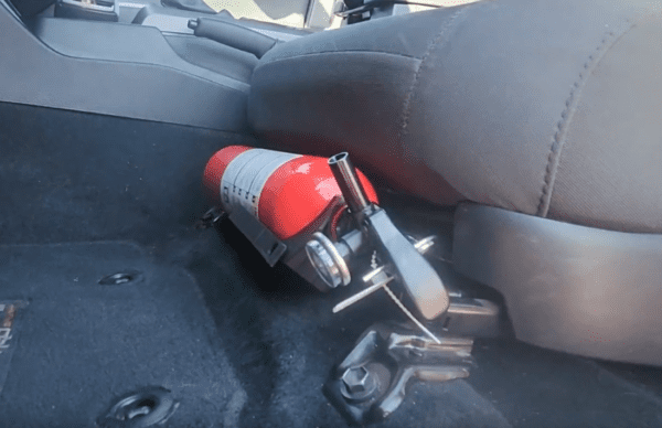 fire extinguisher mounted underneath the driver's seat