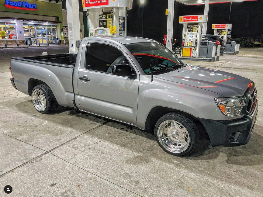 lowered silver toyota tacoma at gas pump