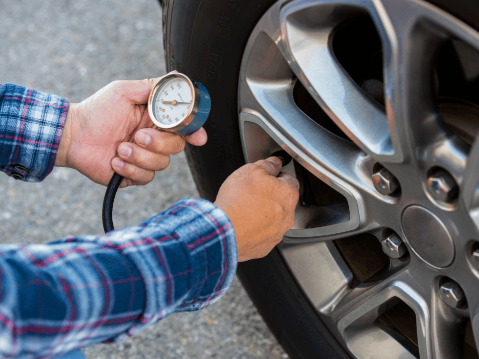 person measuring tire pressure