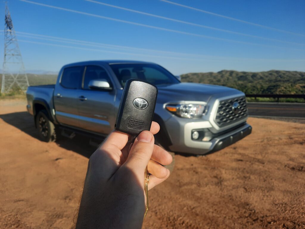 holding key in front of a toyota tacoma