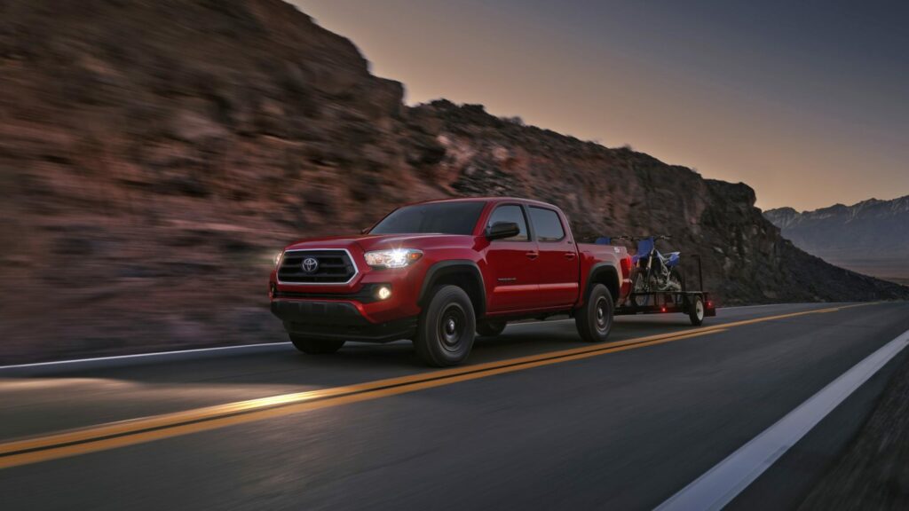 2023 toyota tacoma in barcelona red metallic towing trailer